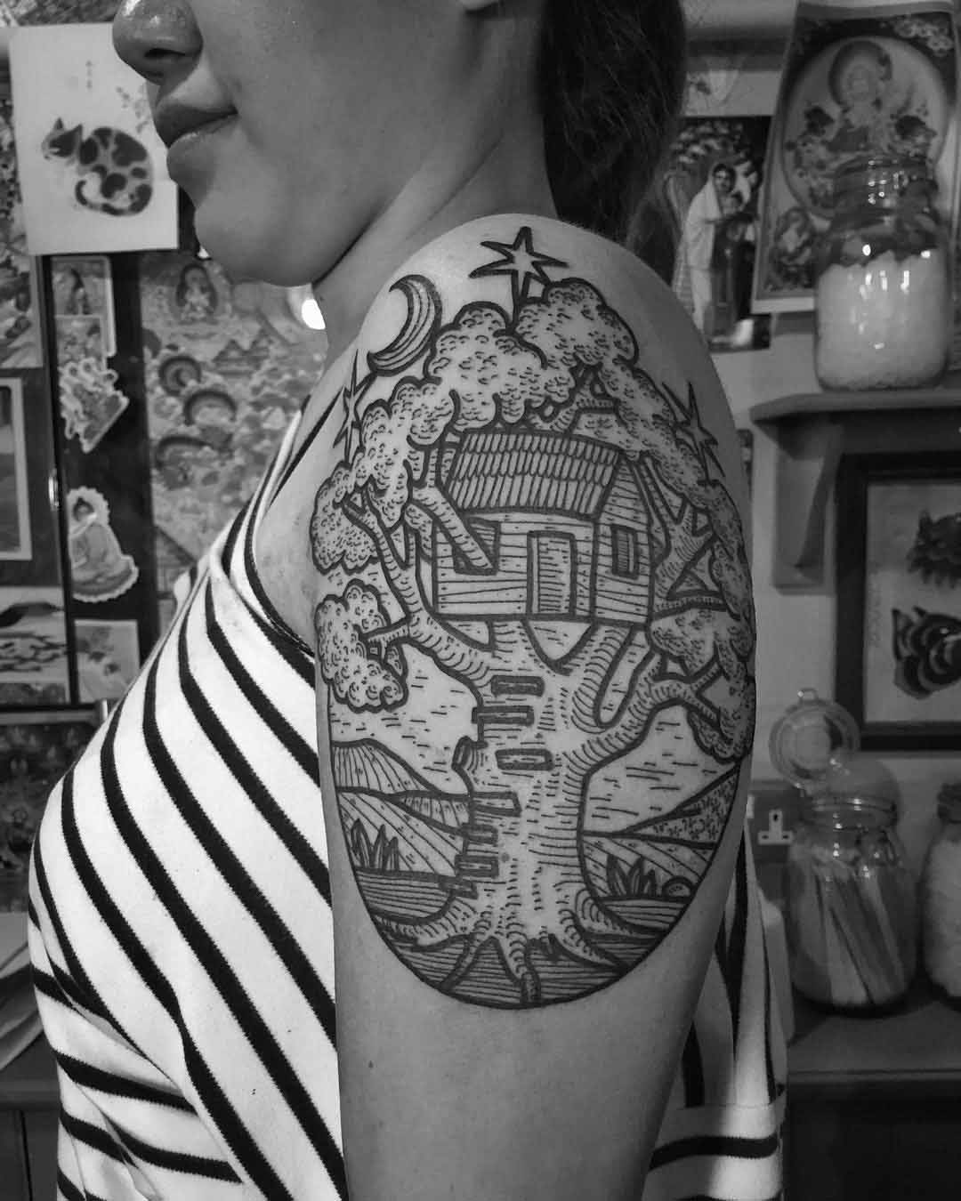 shoulder tattoo of tree house